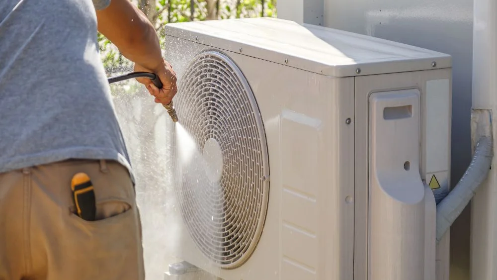 man-cleaning-outdoor-unit